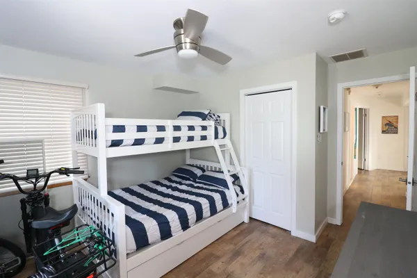 a bedroom with a bed and a chandelier