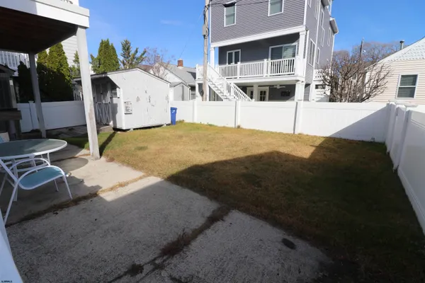a view of a white house with a yard