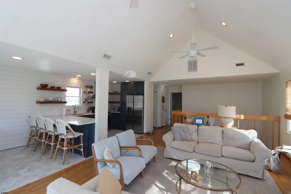 a living room with furniture kitchen and a table