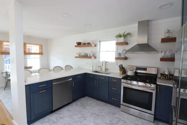 a kitchen with granite countertop a sink and a stove