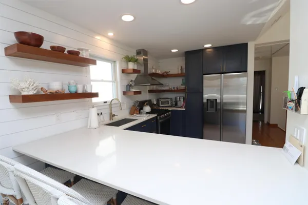 a kitchen with stainless steel appliances a refrigerator and a sink