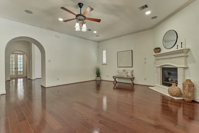 a view of empty room with fireplace and wooden floor