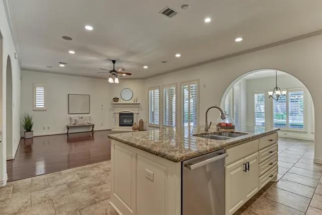 a kitchen with sink stove and living room