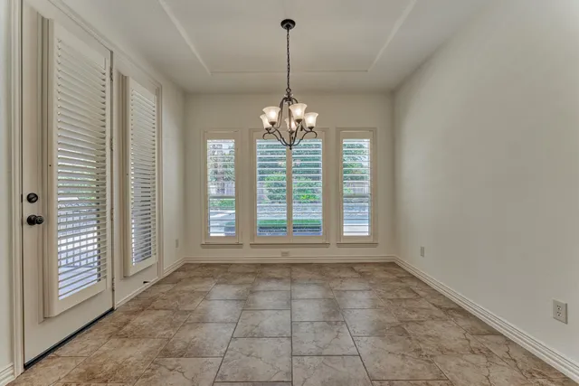 a view of a room with windows and chandelier