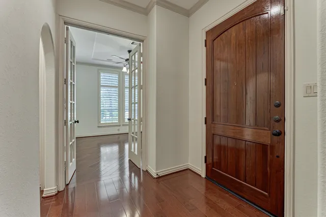 a view of empty room with wooden floor