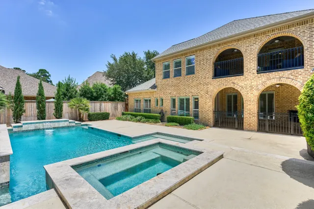 a view of a house with swimming pool and a yard