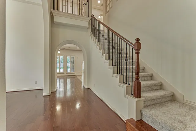 a view of entryway and hall with wooden floor