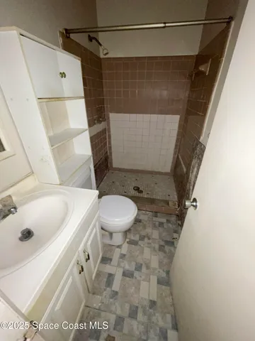 an empty room with a ceiling fan and a window