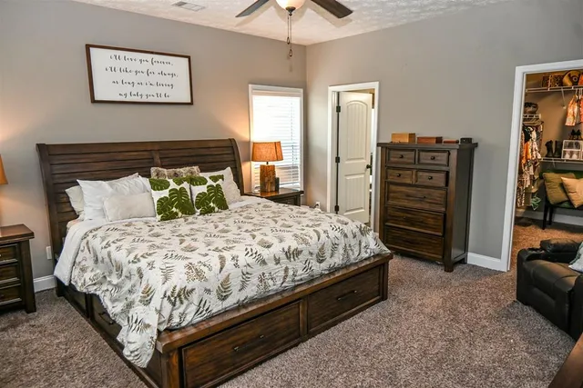 a bedroom with bed and a chandelier