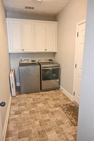 a kitchen with granite countertop a stove a sink and a refrigerator