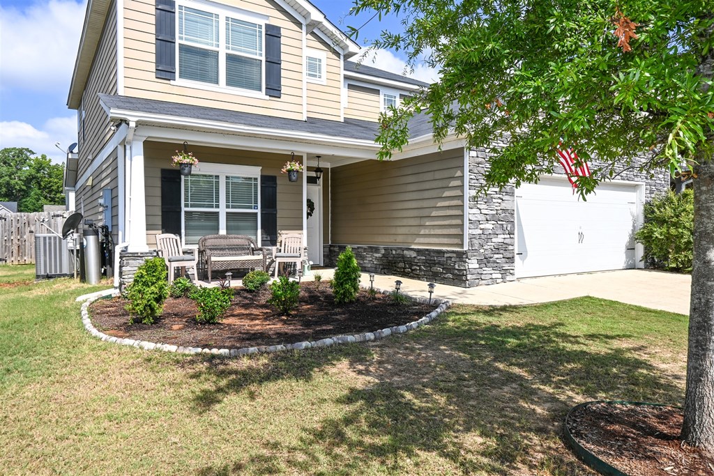 7263 Double Pine Drive Midland, GA 31820 - Photo 2 of 44 a front view of a house with garden
