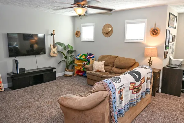 a bedroom with furniture and a flat screen tv