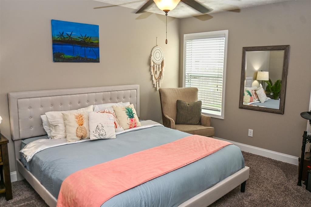 7263 Double Pine Drive Midland, GA 31820 - Photo 29 of 44 a bedroom with a large bed and a window