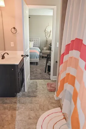 a bedroom with a bed and a mirror