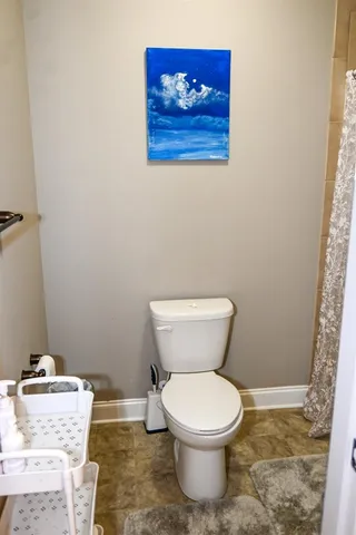 a white toilet sitting next to a bathroom sink
