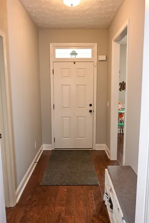 an entryway with wooden floor