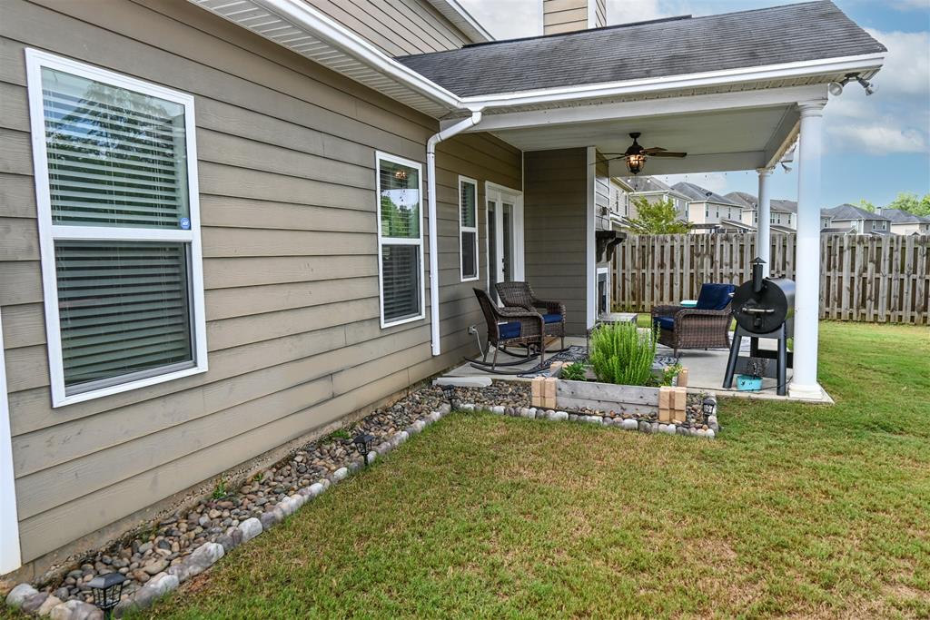 7263 Double Pine Drive Midland, GA 31820 - Photo 8 of 44 a view of a chair and tables in patio of the house