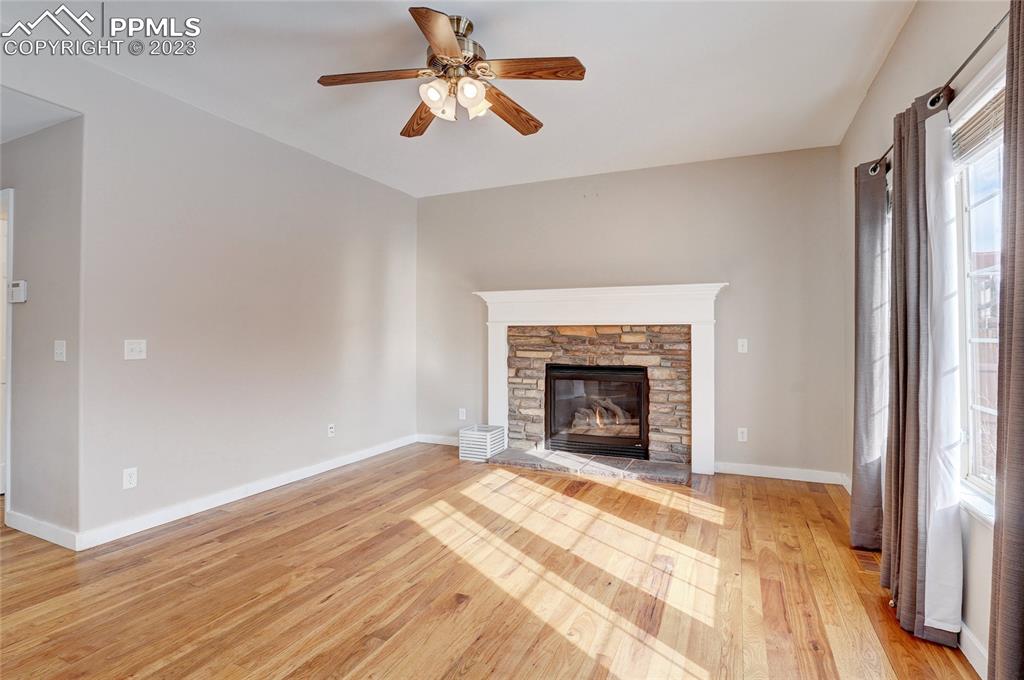 409 Avocet Loop Colorado Springs, CO 80921 - Photo 14 of 34 a view of empty room with wooden floor and fireplace