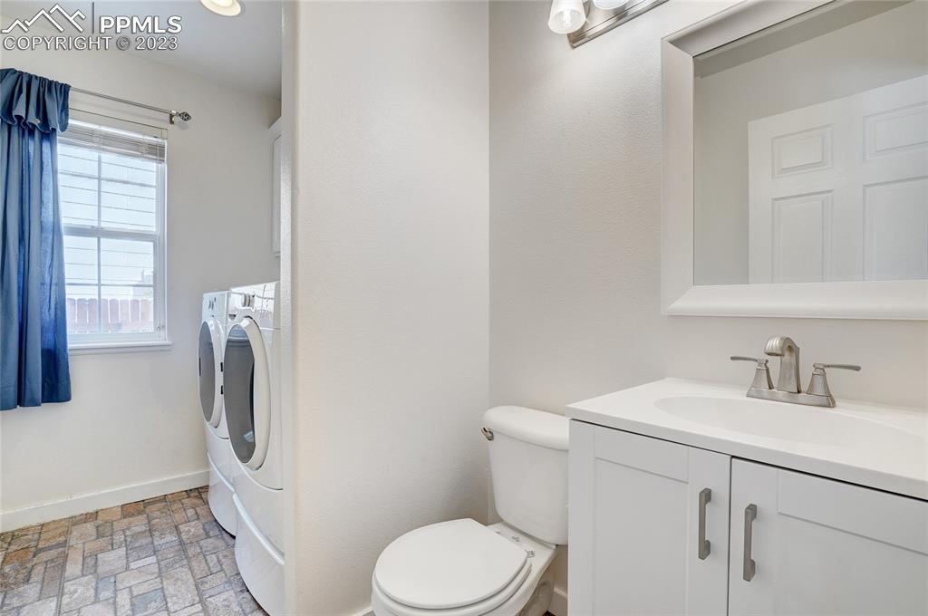 409 Avocet Loop Colorado Springs, CO 80921 - Photo 16 of 34 a white toilet sitting next to a bathroom sink