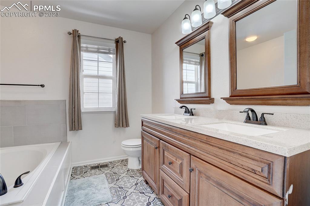 409 Avocet Loop Colorado Springs, CO 80921 - Photo 20 of 34 a bathroom with a sink a toilet and bathtub
