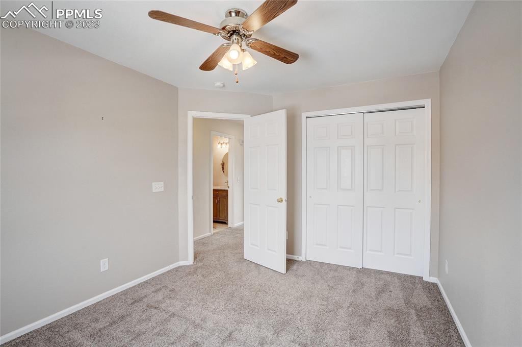 409 Avocet Loop Colorado Springs, CO 80921 - Photo 23 of 34 an empty room with closet and a chandelier fan