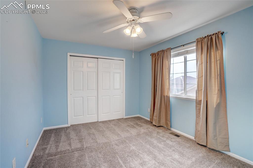 409 Avocet Loop Colorado Springs, CO 80921 - Photo 26 of 34 an empty room with windows and fan