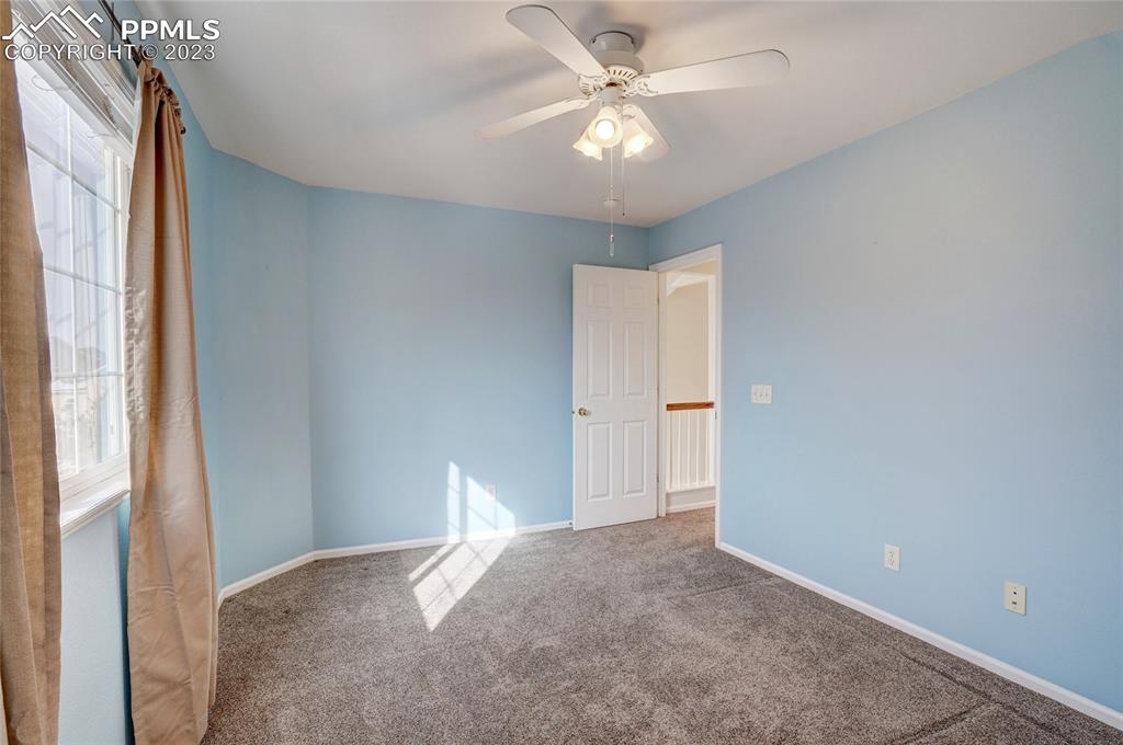 409 Avocet Loop Colorado Springs, CO 80921 - Photo 27 of 34 a view of a livingroom with an empty space and a ceiling fan