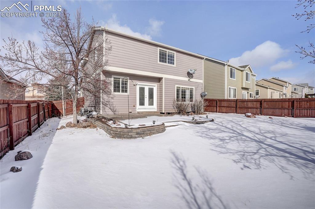 409 Avocet Loop Colorado Springs, CO 80921 - Photo 29 of 34 a view of a house with a yard covered in snow