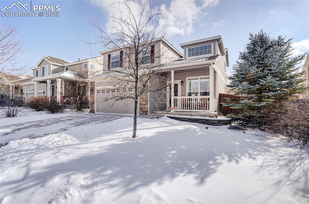 409 Avocet Loop Colorado Springs, CO 80921 - Photo 3 of 34 a front view of a house with a yard and garage