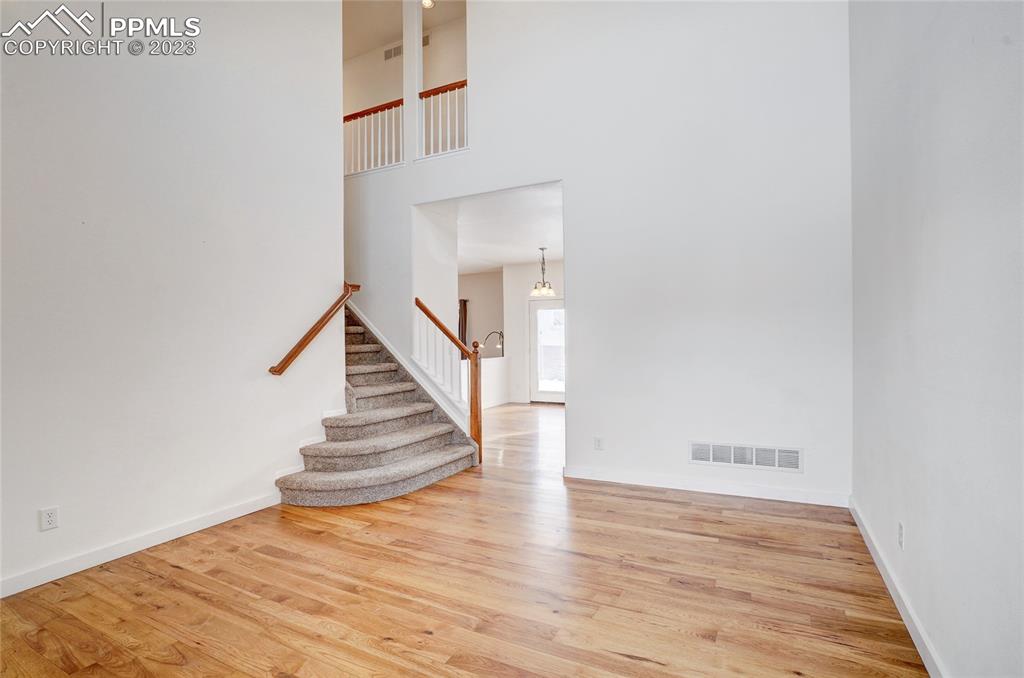 409 Avocet Loop Colorado Springs, CO 80921 - Photo 7 of 34 a view of entryway and hall with wooden floor