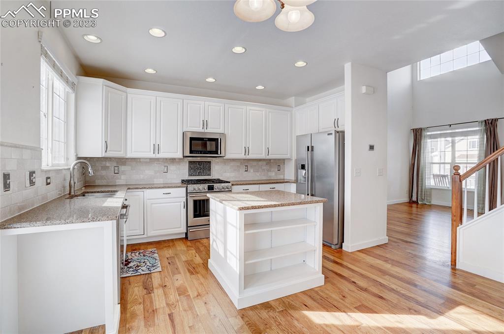 409 Avocet Loop Colorado Springs, CO 80921 - Photo 8 of 34 a kitchen with a stove a sink and a refrigerator