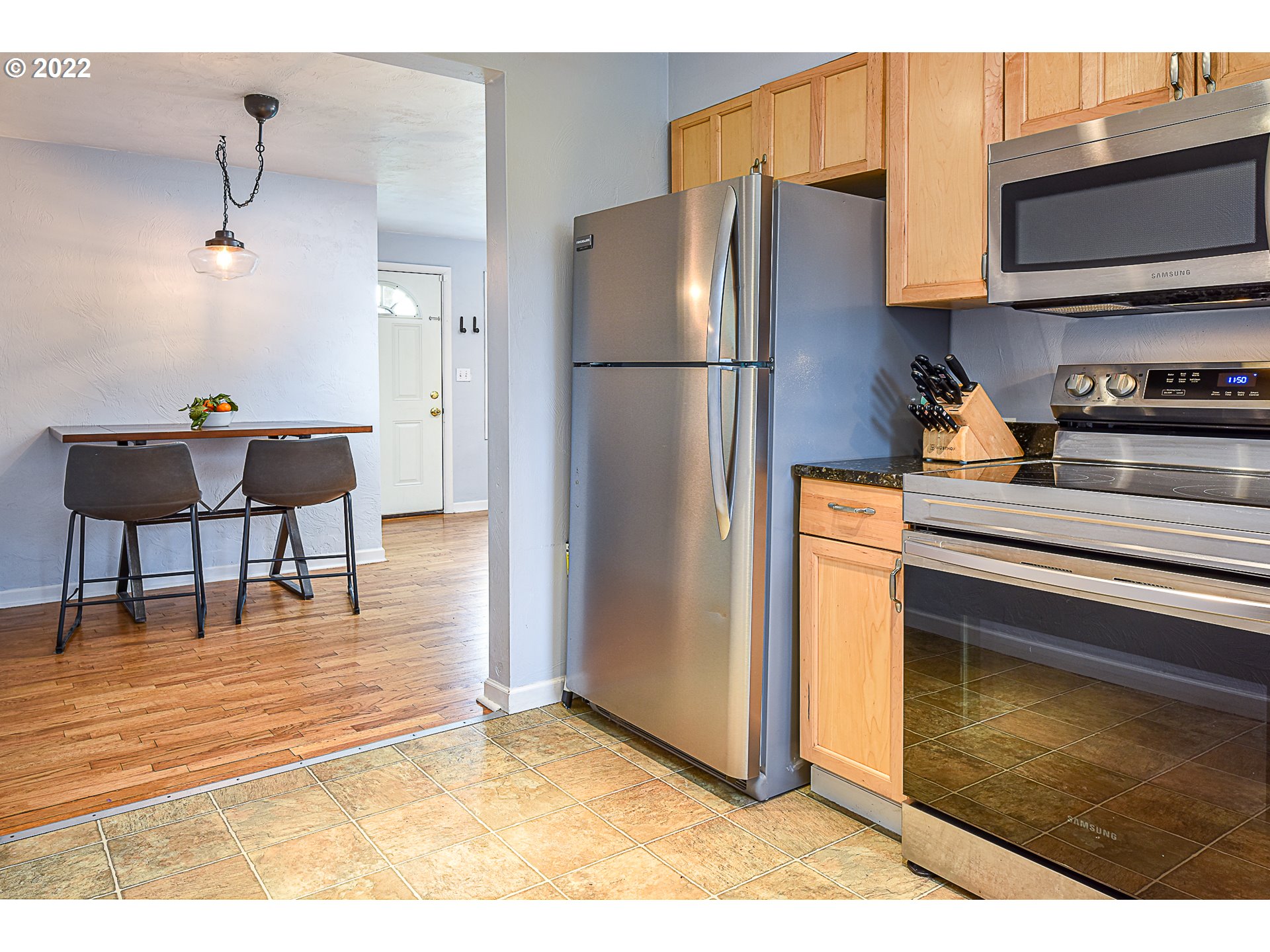 3241 Pheasant Boulevard Springfield, OR 97477 - Photo 12 of 28 a kitchen with stainless steel appliances granite countertop a refrigerator a stove and a sink with wooden floor