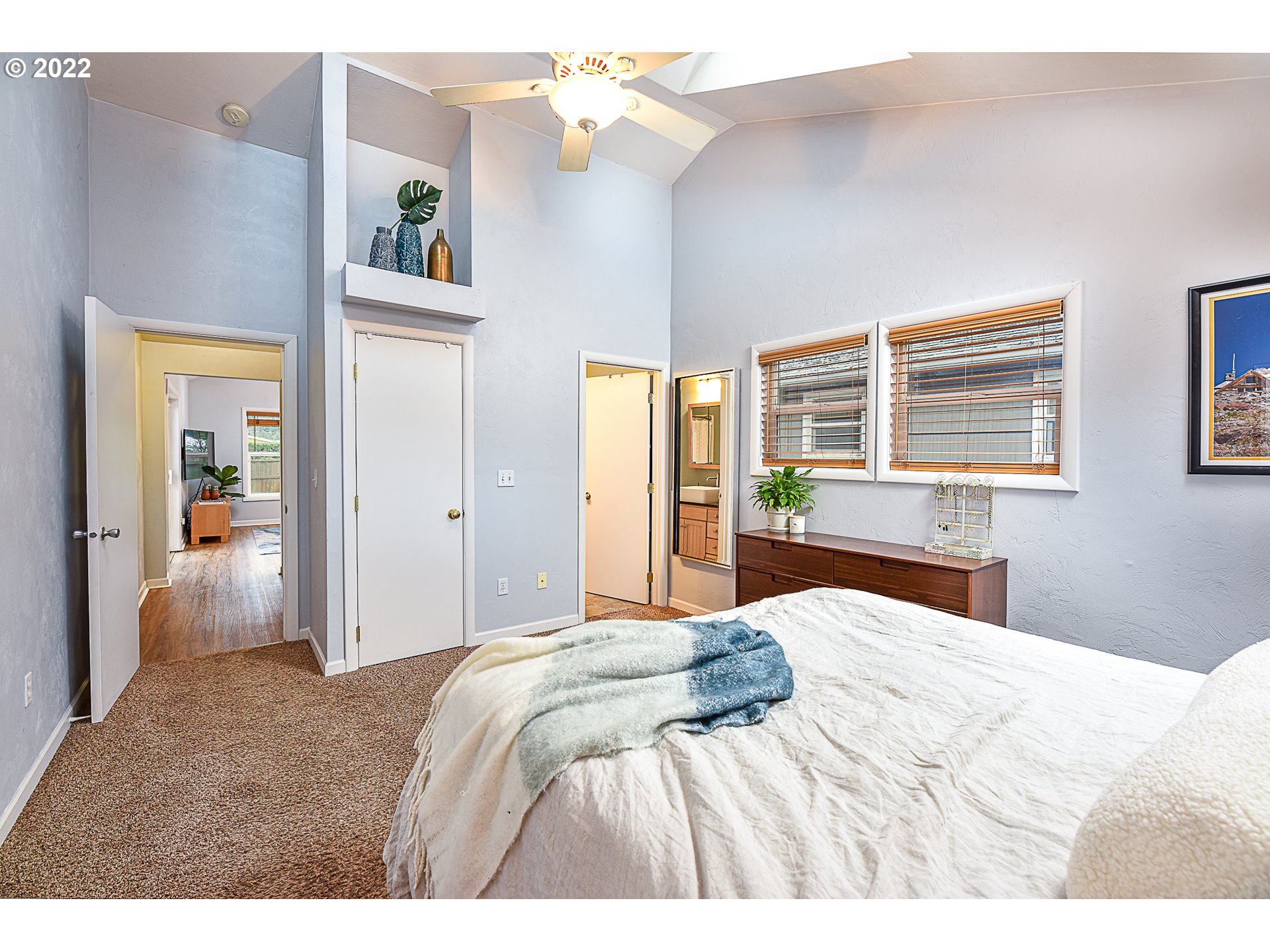3241 Pheasant Boulevard Springfield, OR 97477 - Photo 17 of 28 a bedroom with a large bed and a chandelier