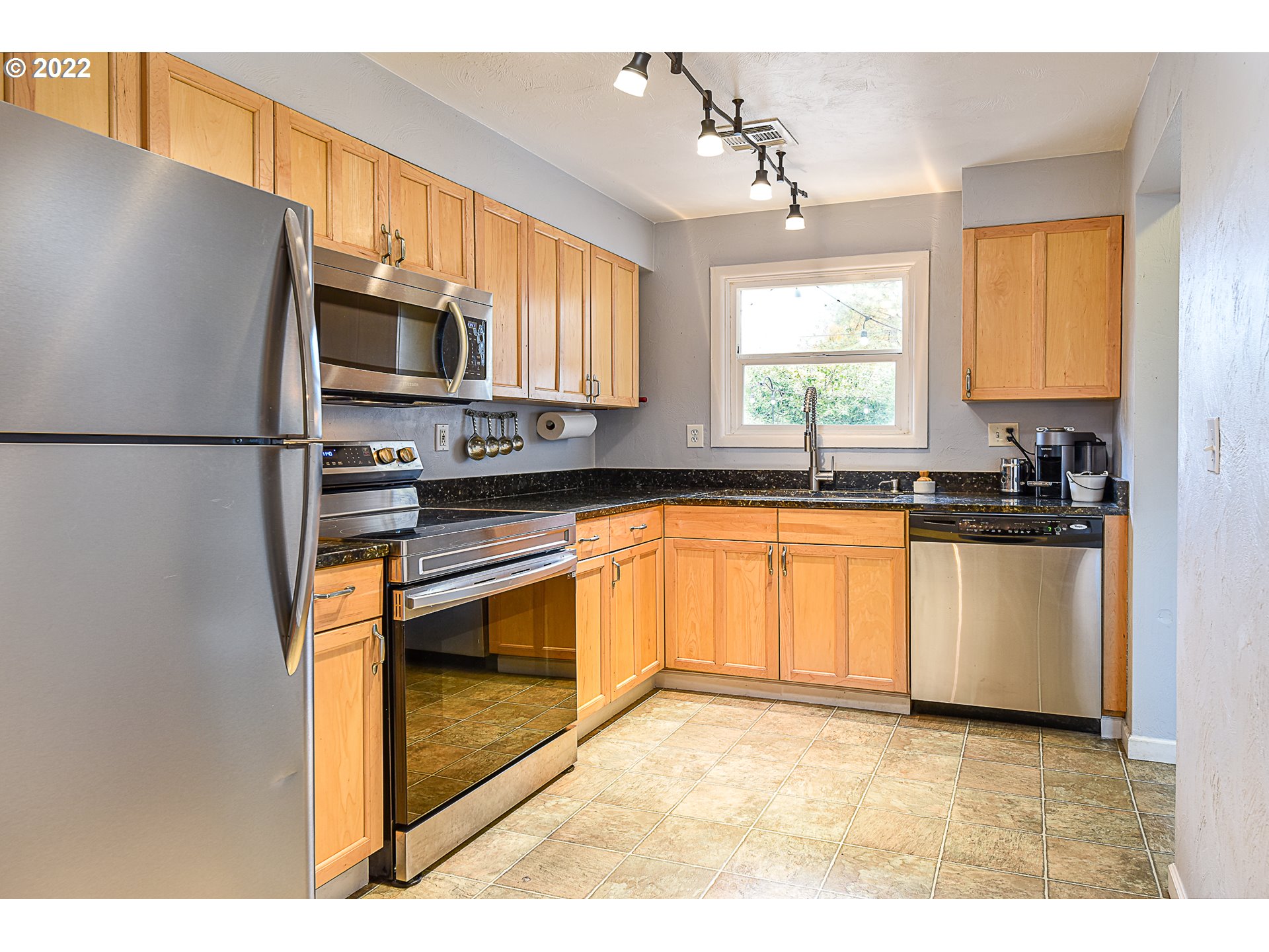 3241 Pheasant Boulevard Springfield, OR 97477 - Photo 8 of 28 a kitchen with stainless steel appliances a refrigerator sink stove microwave and cabinets