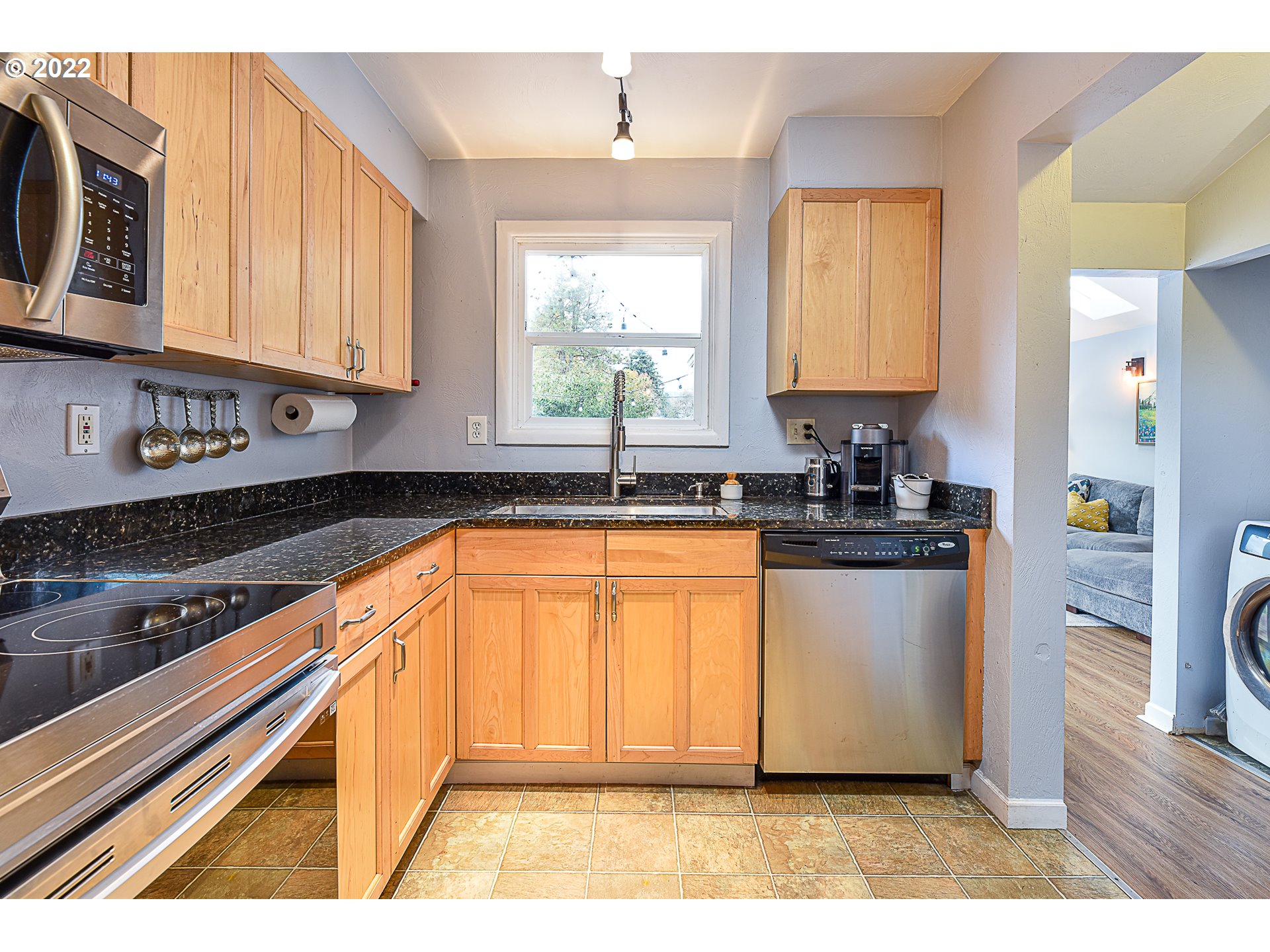 3241 Pheasant Boulevard Springfield, OR 97477 - Photo 9 of 28 a kitchen with stainless steel appliances granite countertop a stove a sink and a microwave
