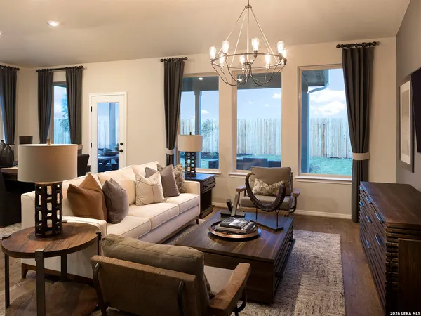 a living room with furniture a lamp and a chandelier