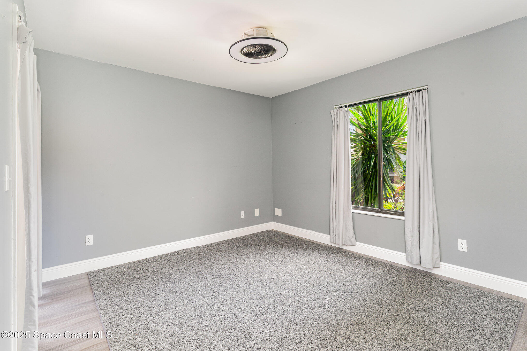 1040 Abada Court Northeast, Unit 109 Palm Bay, FL 32905 - Photo 11 of 25 an empty room with windows
