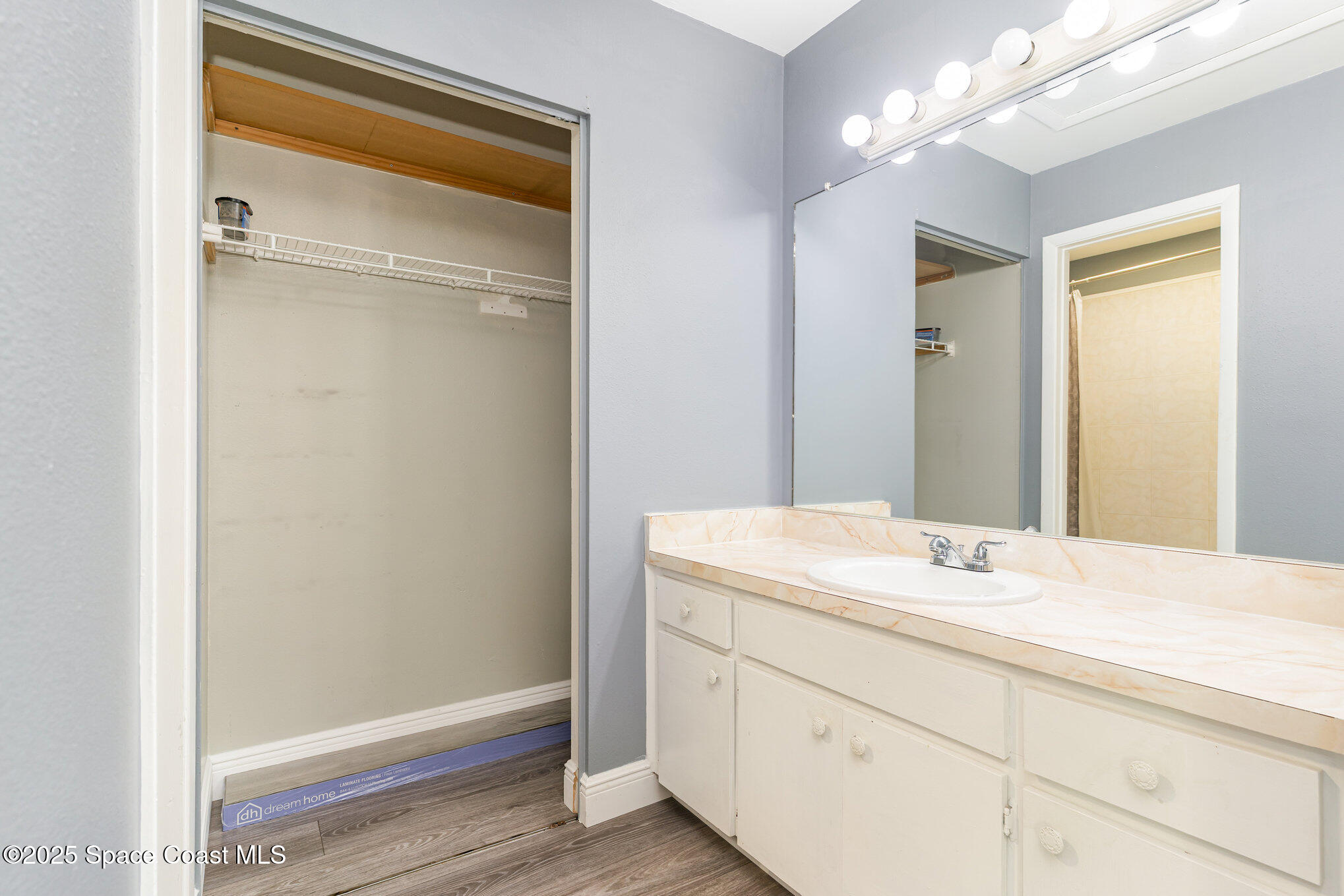 1040 Abada Court Northeast, Unit 109 Palm Bay, FL 32905 - Photo 12 of 25 a bathroom with a sink a vanity and a mirror