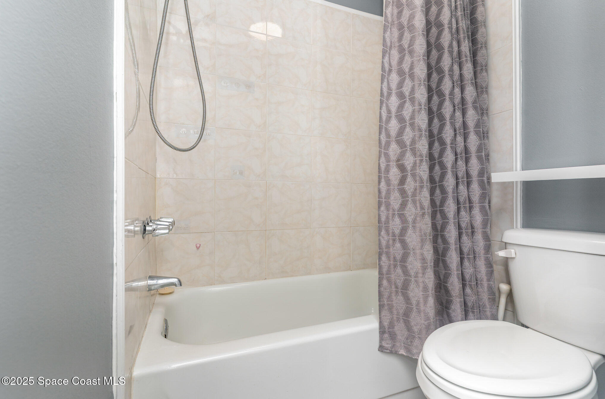 1040 Abada Court Northeast, Unit 109 Palm Bay, FL 32905 - Photo 13 of 25 a white toilet sitting next to a bath tub and shower