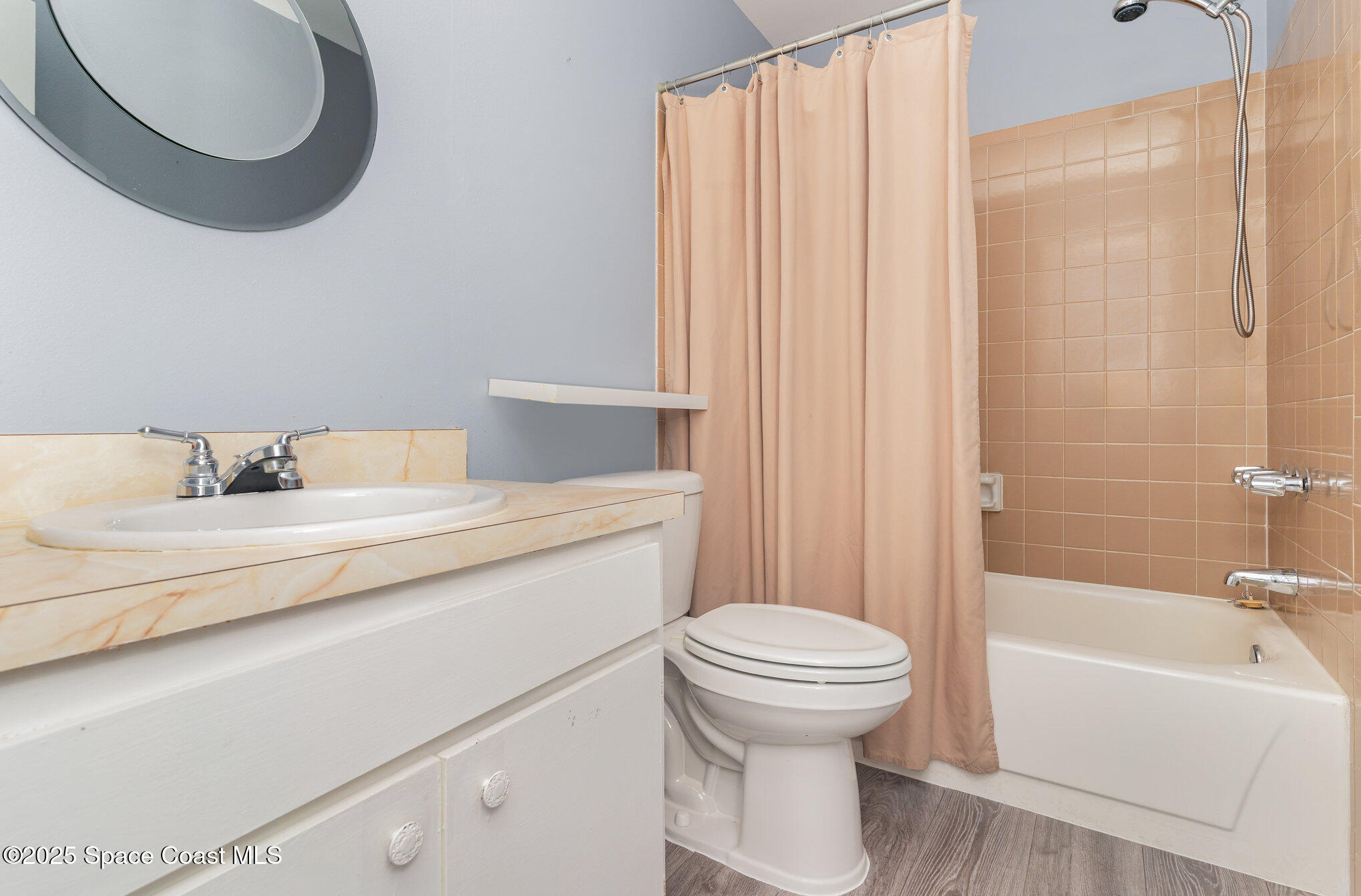 1040 Abada Court Northeast, Unit 109 Palm Bay, FL 32905 - Photo 16 of 25 a bathroom with a sink a toilet and a bathtub