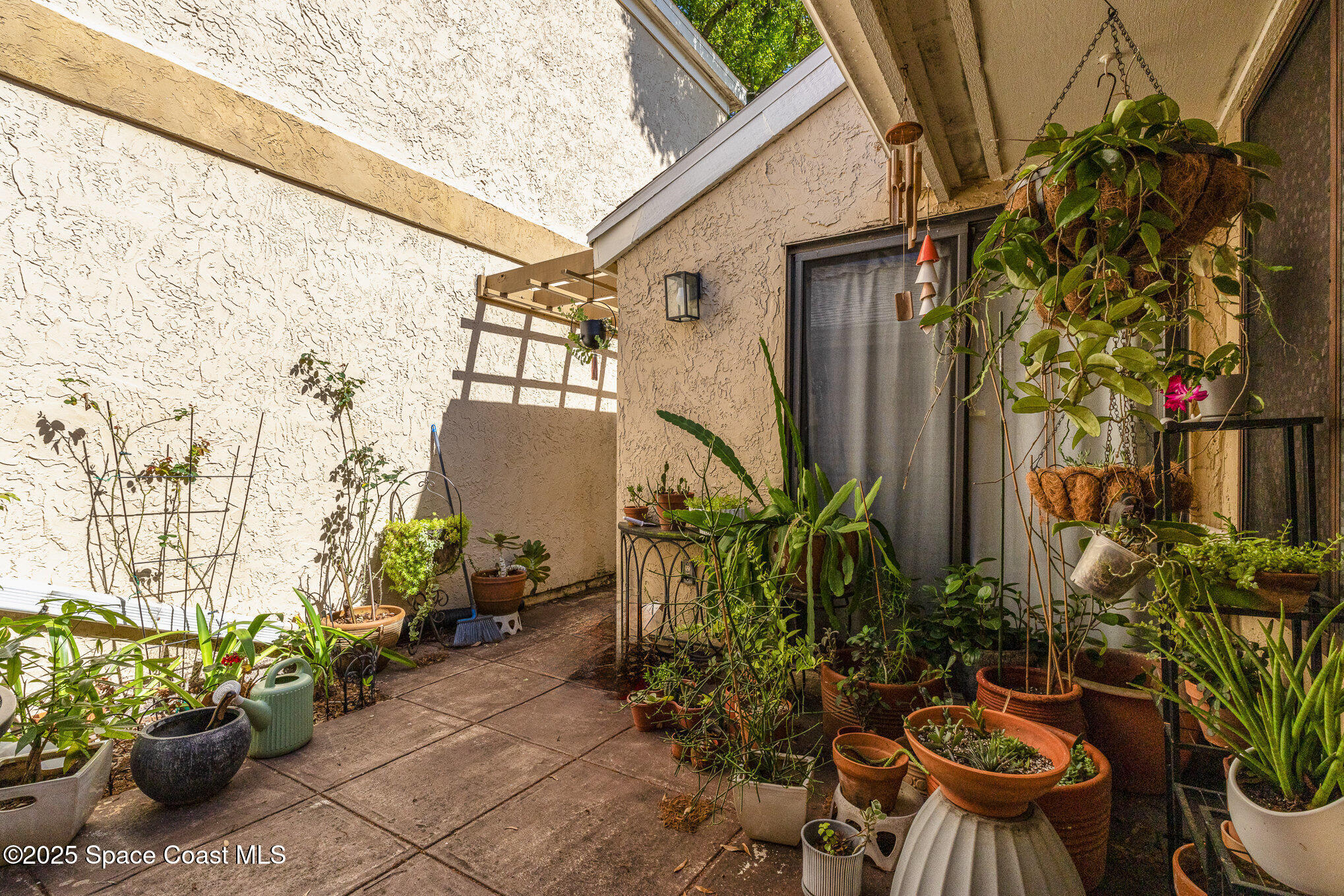 1040 Abada Court Northeast, Unit 109 Palm Bay, FL 32905 - Photo 17 of 25 a view of a backyard with chair and flower plants