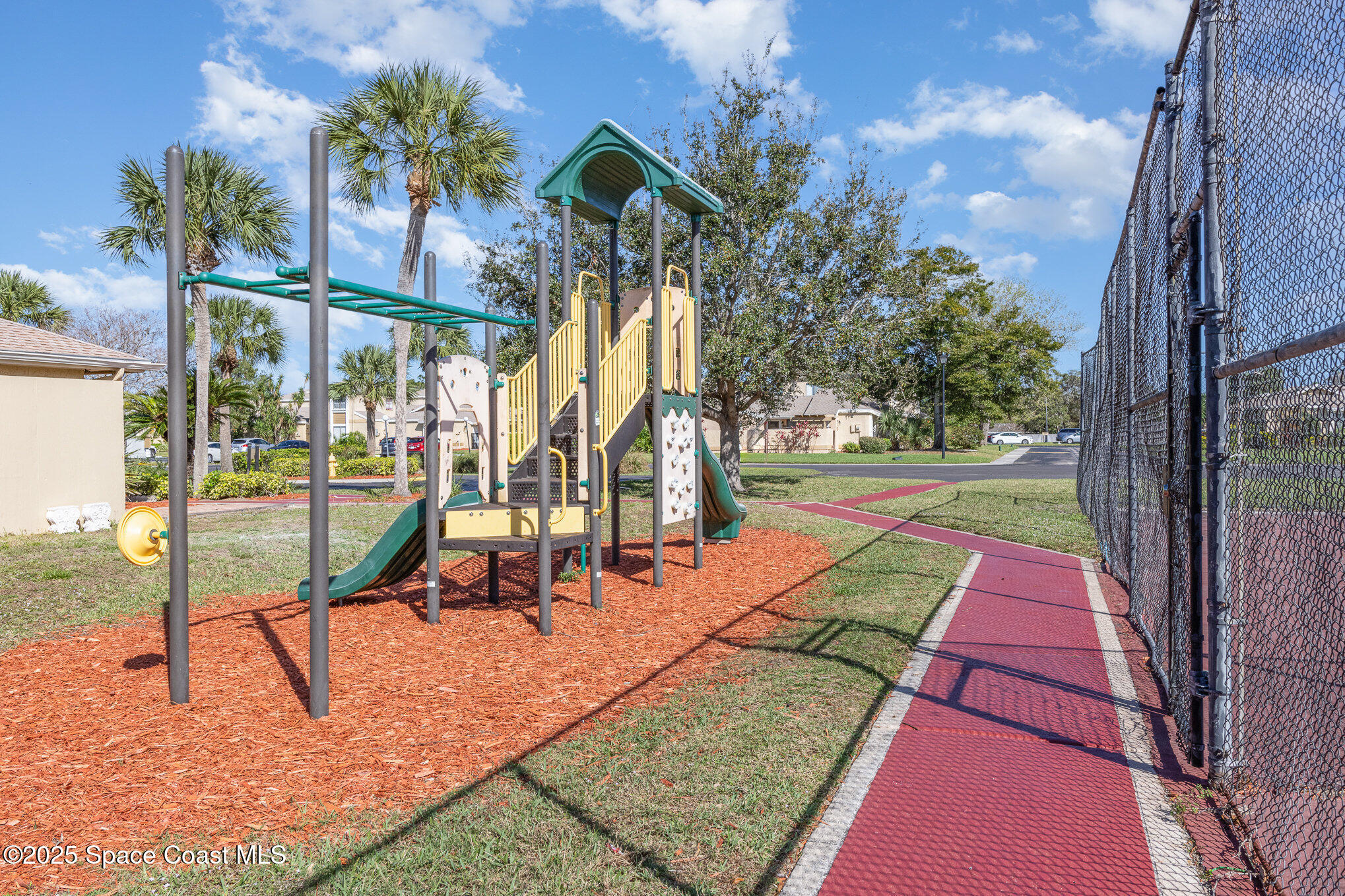 1040 Abada Court Northeast, Unit 109 Palm Bay, FL 32905 - Photo 21 of 25 a view of a park with swings
