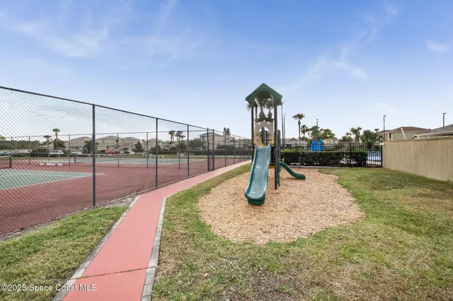 a sign board with flower plants and wooden fence