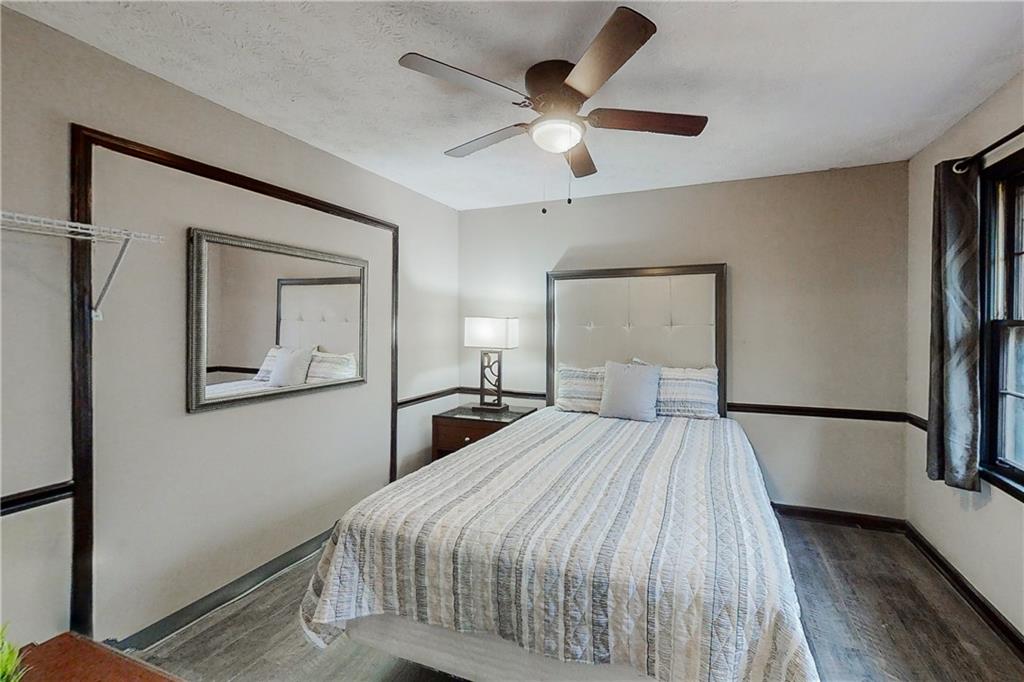 2284 Emerald Springs Drive Decatur, GA 30035 - Photo 11 of 30 a bedroom with a large bed and a chandelier