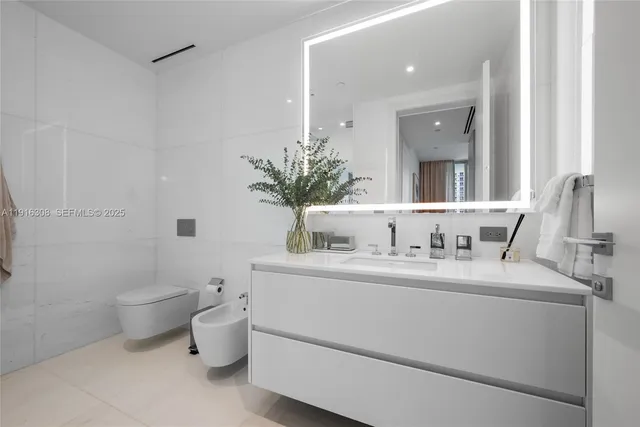 a bedroom with a bed and window with bathroom