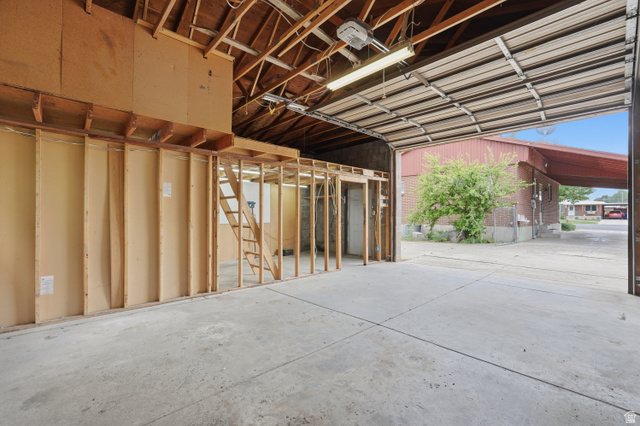 378 West 200 South Bountiful, UT 84010 - Photo 28 of 32 Spacious garage with exposed wood rafters, concrete flooring, and an overhead door
