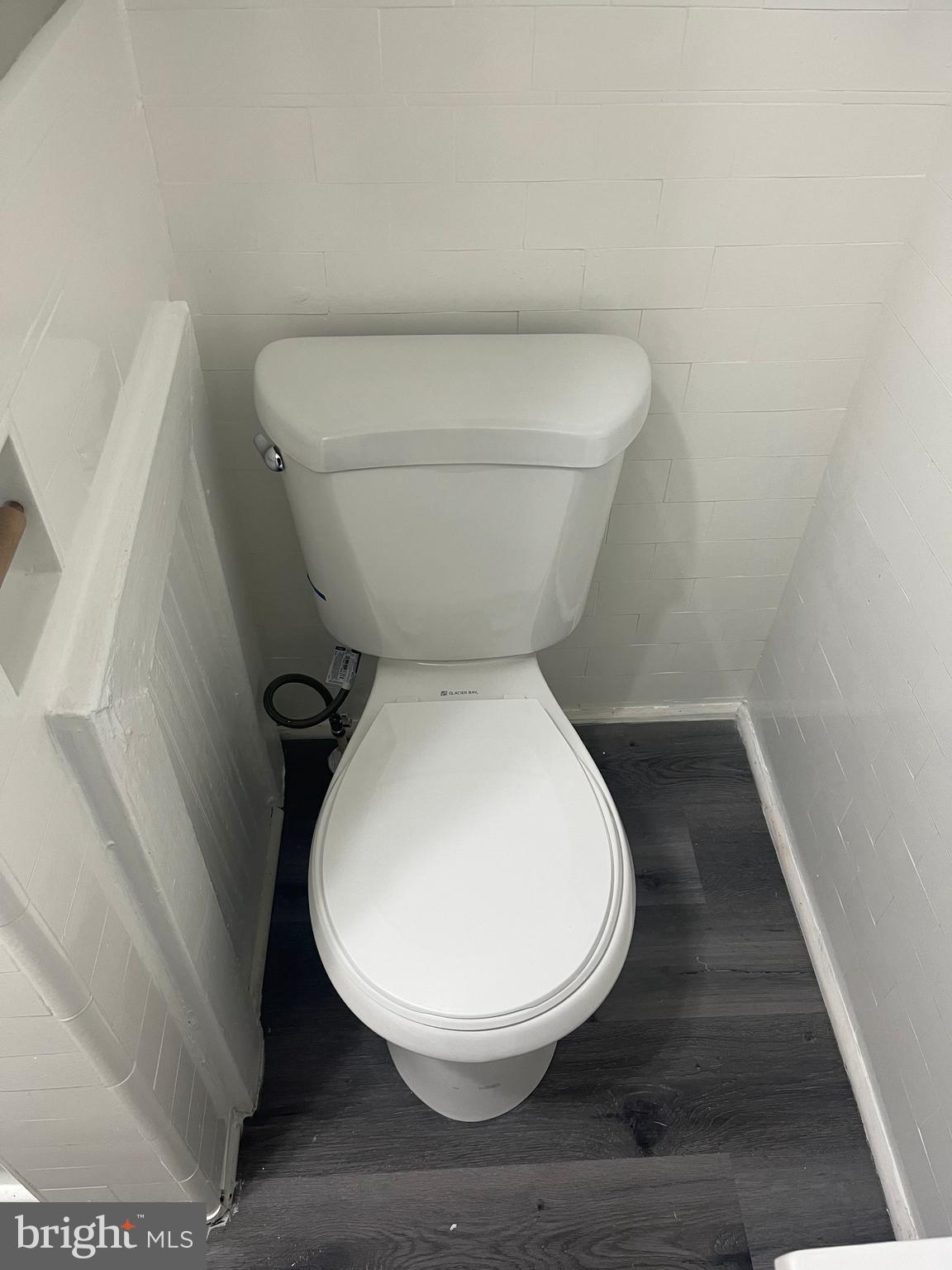 133 North Monastery Avenue Baltimore, MD 21229 - Photo 12 of 29 a small bathroom with a toilet and a rug