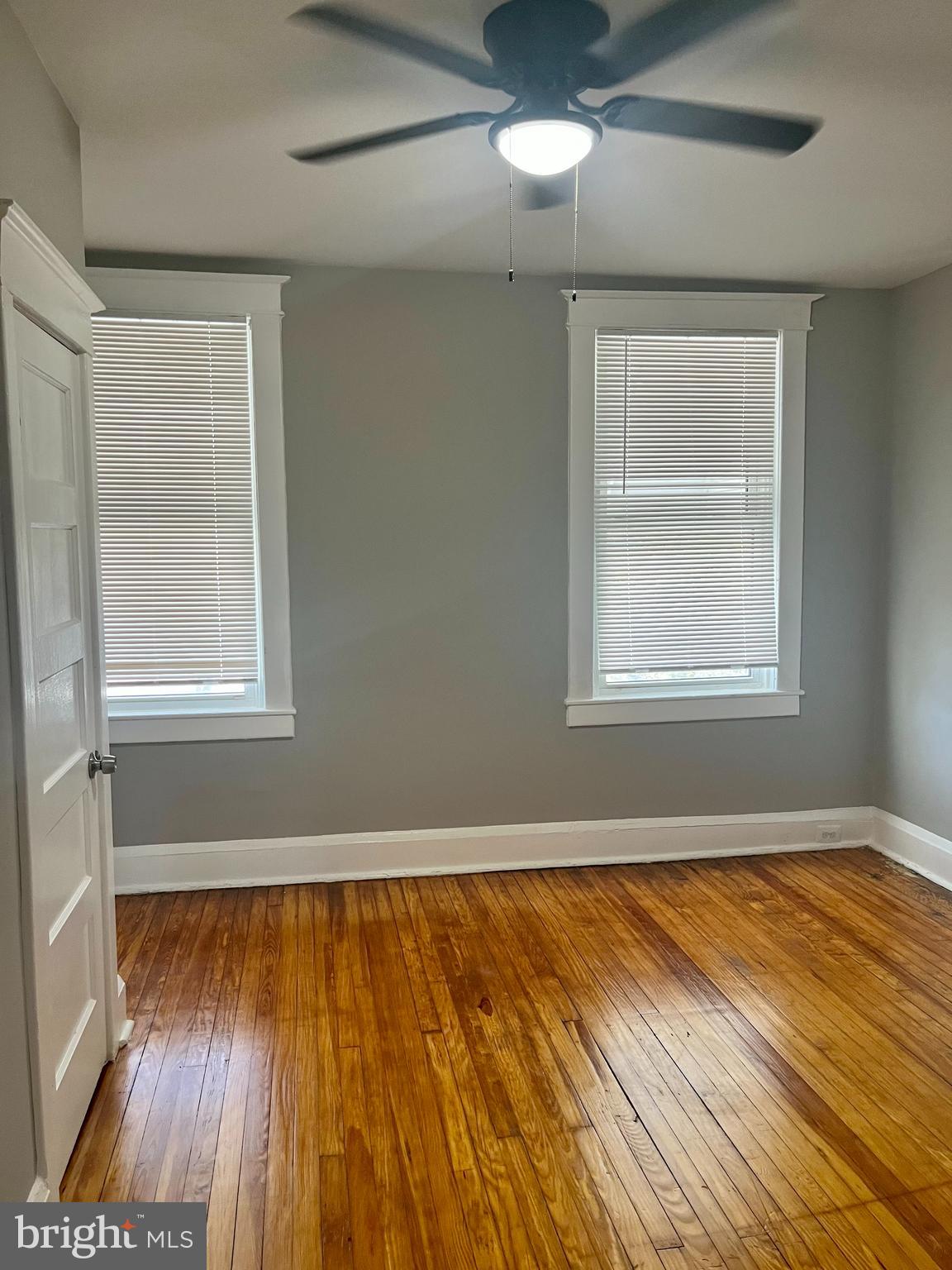133 North Monastery Avenue Baltimore, MD 21229 - Photo 16 of 29 a view of an empty room with wooden floor and a window