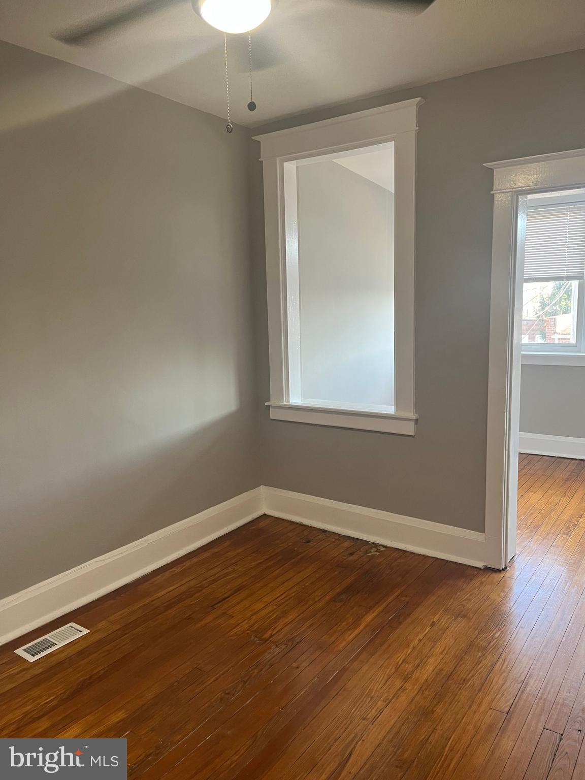 133 North Monastery Avenue Baltimore, MD 21229 - Photo 20 of 29 an empty room with wooden floor and windows