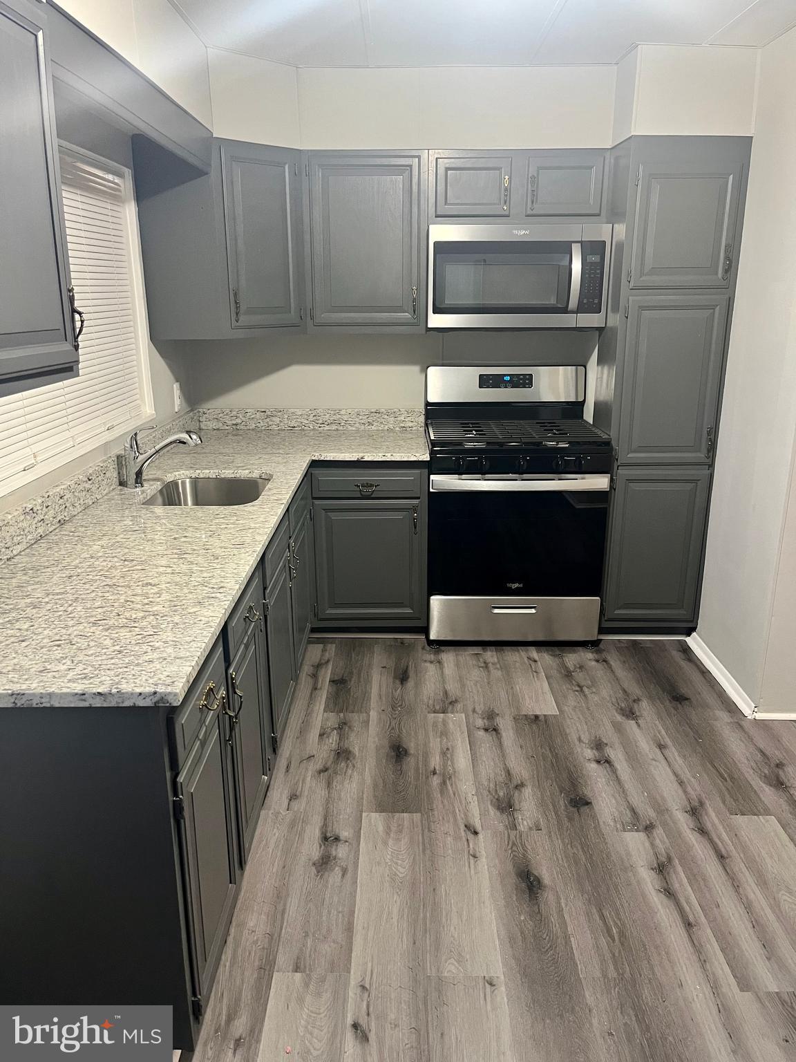 133 North Monastery Avenue Baltimore, MD 21229 - Photo 7 of 29 a kitchen with a sink stove and microwave